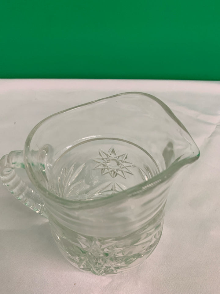 HEAVY CUT GLASS STAR PATTERN PITCHER.