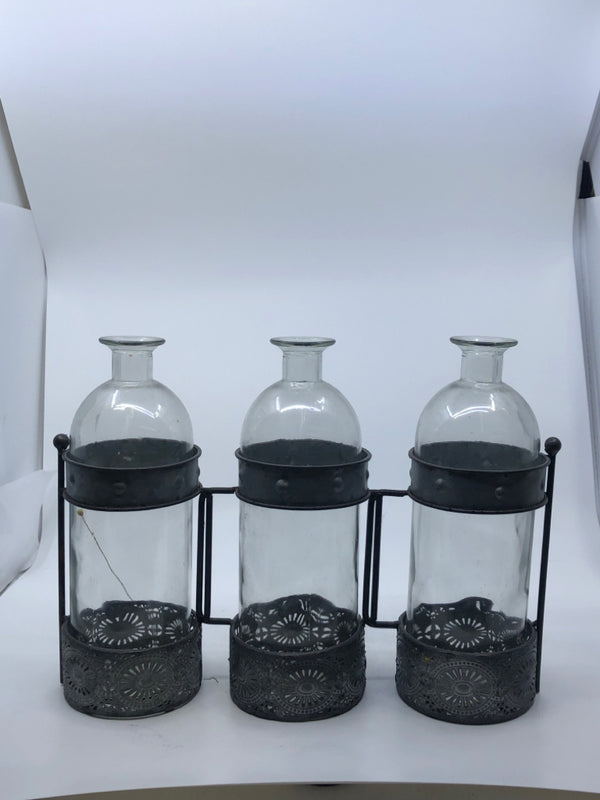 3 GLASS BOTTLE IN GALVANIZED HOLDER.