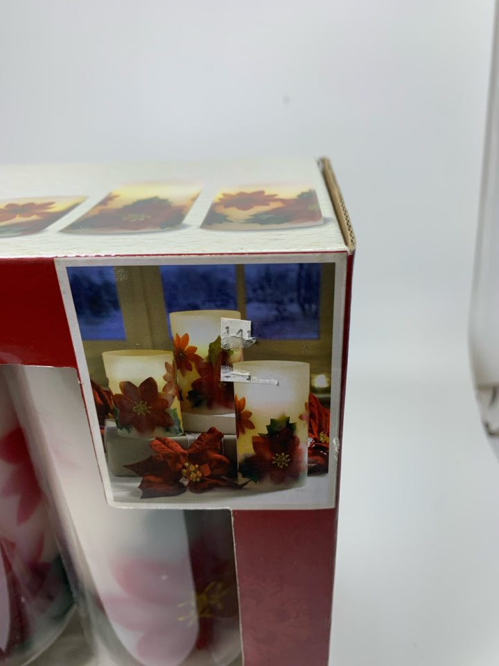 IN BOX 3 POINSETTIA LET CANDLE SET.