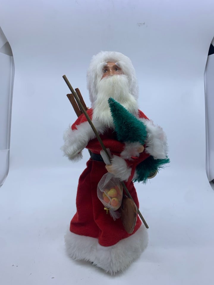 1990 BYERS CHOICE SANTA HOLDING SACK OF TOYS.