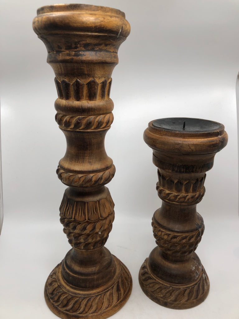 2 WOOD CARVED CANDLE HOLDERS W/BURNT FINISH.