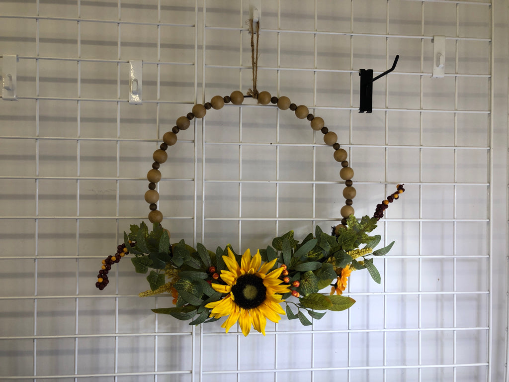 WOOD BEADED WREATH W/ FAUX SUNFLOWER.