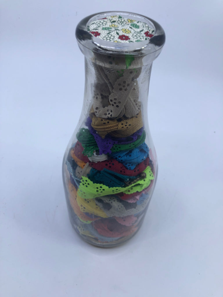 GLASS BOTTLE FILLED W/ZIPPER FABRIC DECOR.