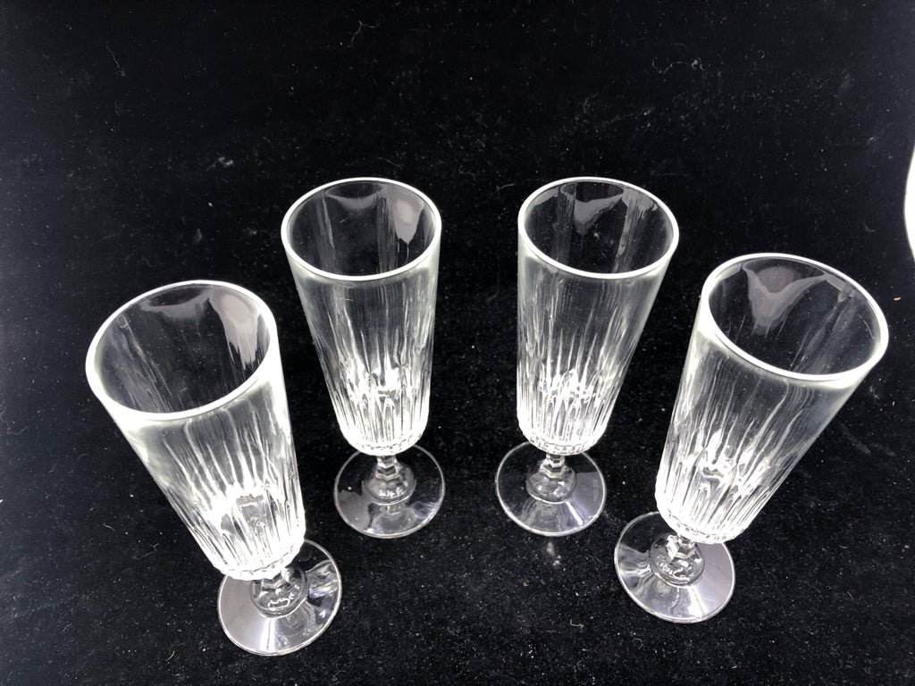 4 FOOTED CHAMPAGNE GLASS CUT GLASS BOTTOM.