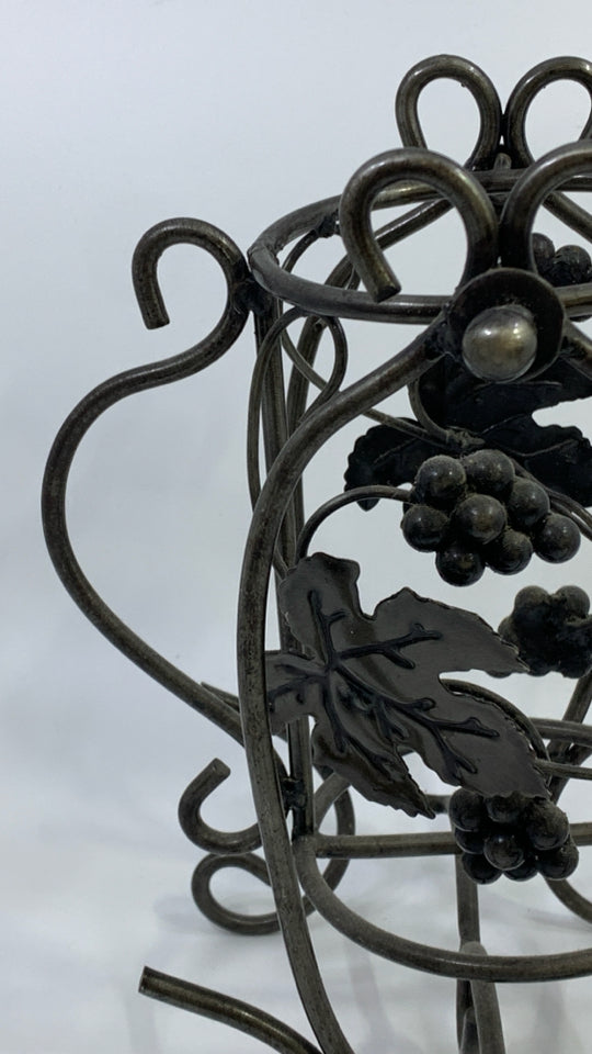 METAL SCROLL WINE BOTTLE HOLDER W/LEAVES.