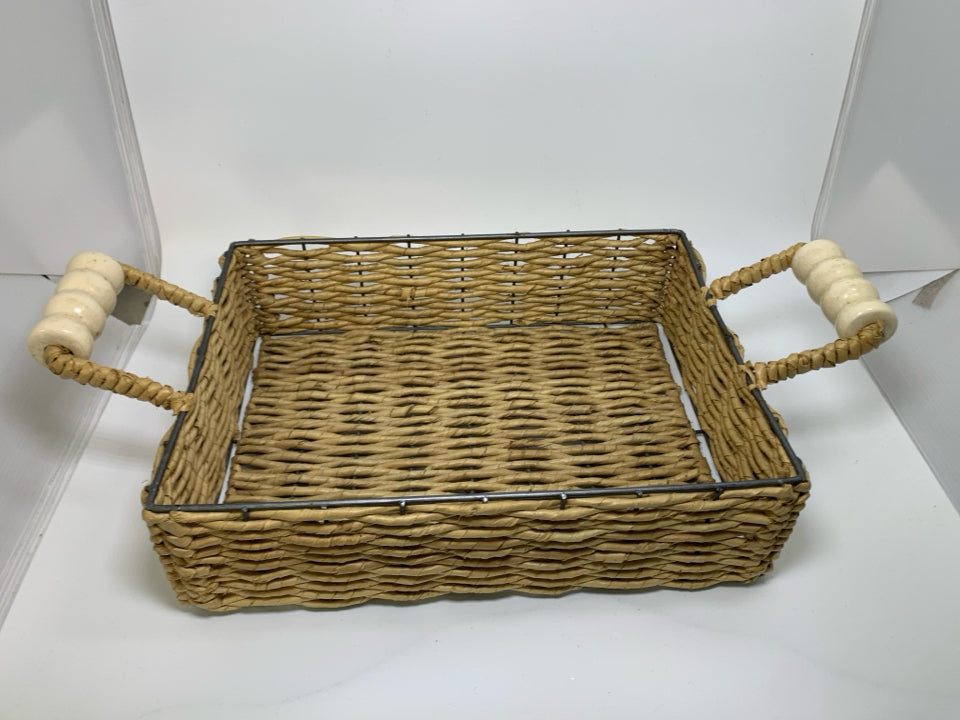 WOVEN BASKET TRAY W/ CREAM CERAMIC HANDLES.