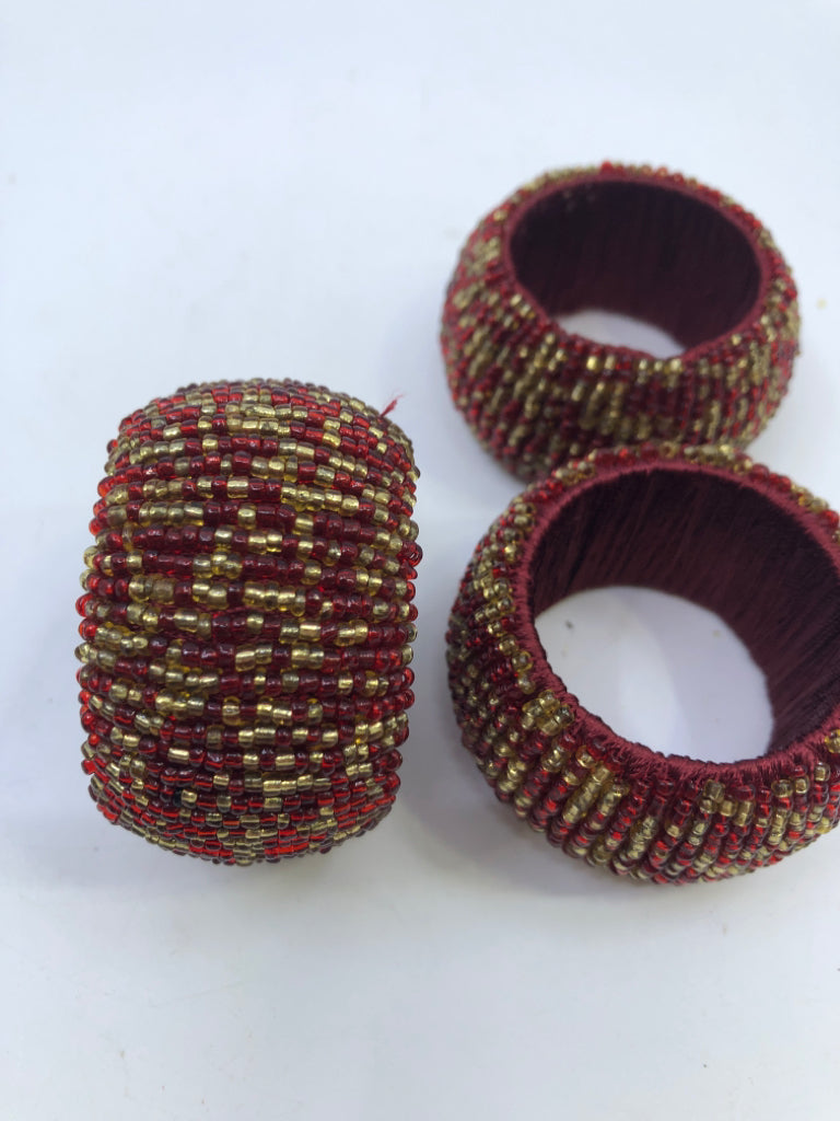 4 RED BEADED NAPKIN RINGS.