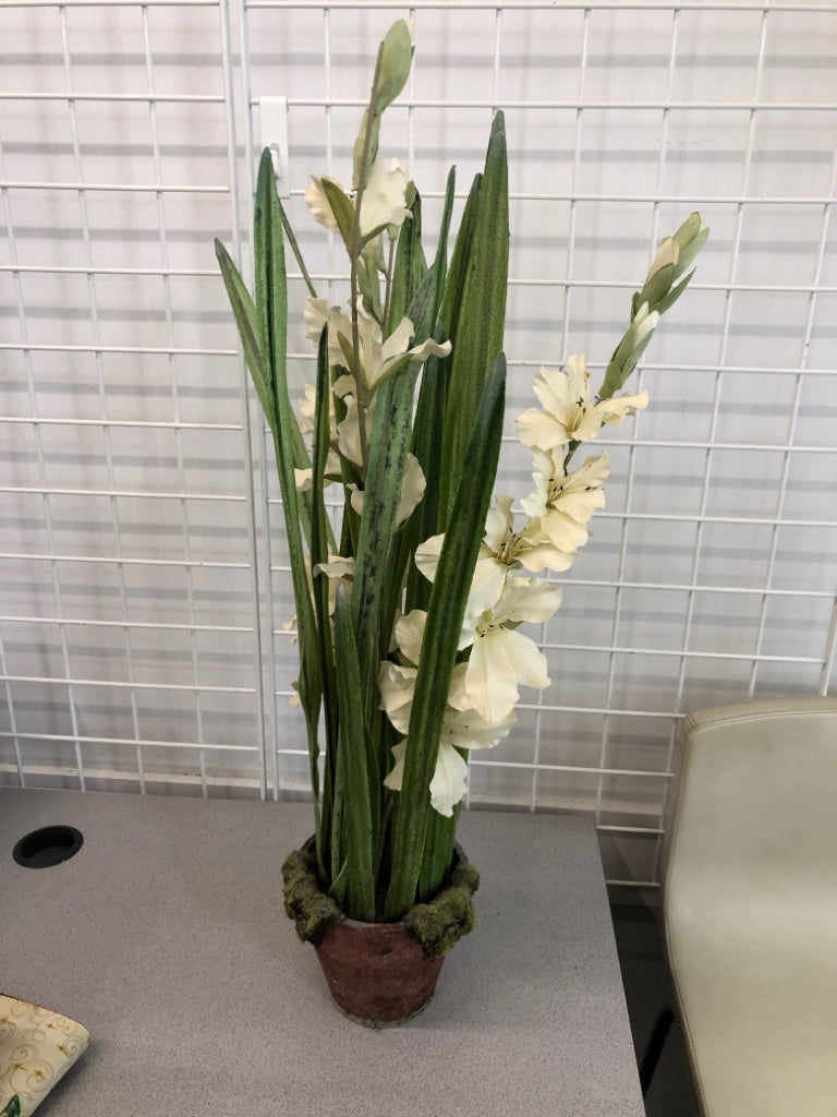 FAUX FLORALS IN MOSS POT.