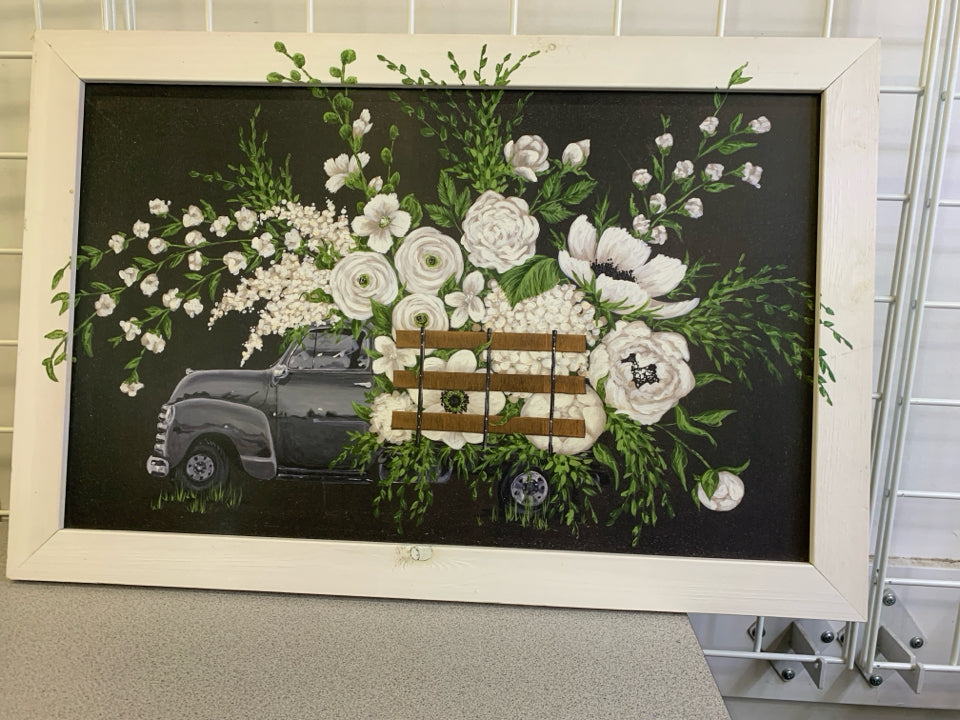 BLACK TRUCK W WHITE FLORAL IN WHITE FRAME WALL DECOR.