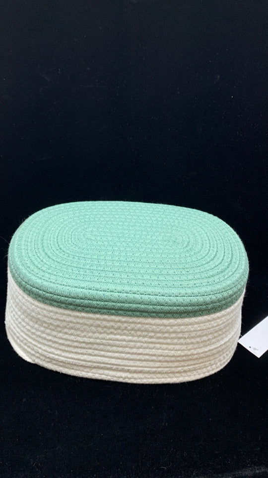 GREEN/WHITE WOVEN OVAL STORAGE BIN.