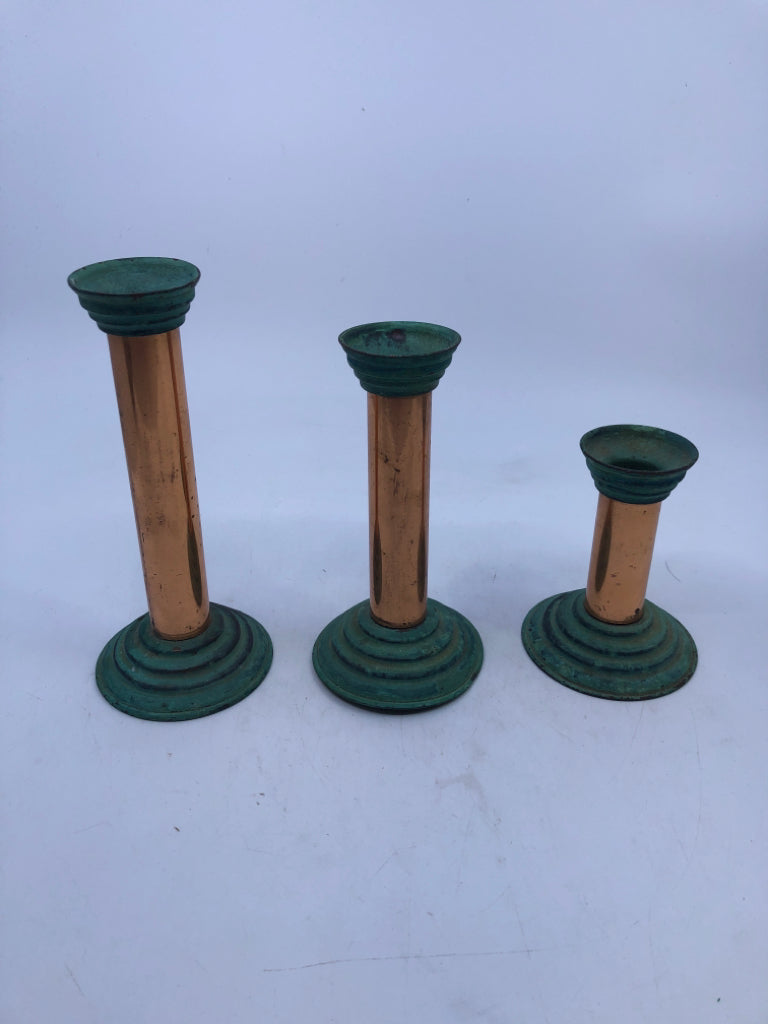 3 COPPER CANDLE HOLDERS W CANDLES.