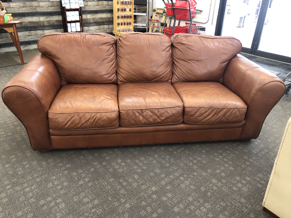 BROWN FAUX LEATHER COUCH.