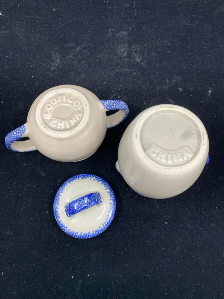 CREAM AND BLUE POTTERY CREAMER AND SUGAR.