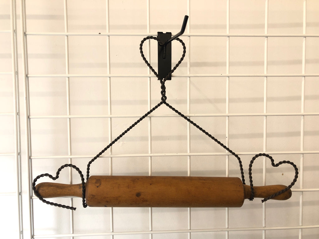 PRIMITIVE ROLLING PIN IN METAL WIRE HOLDER.