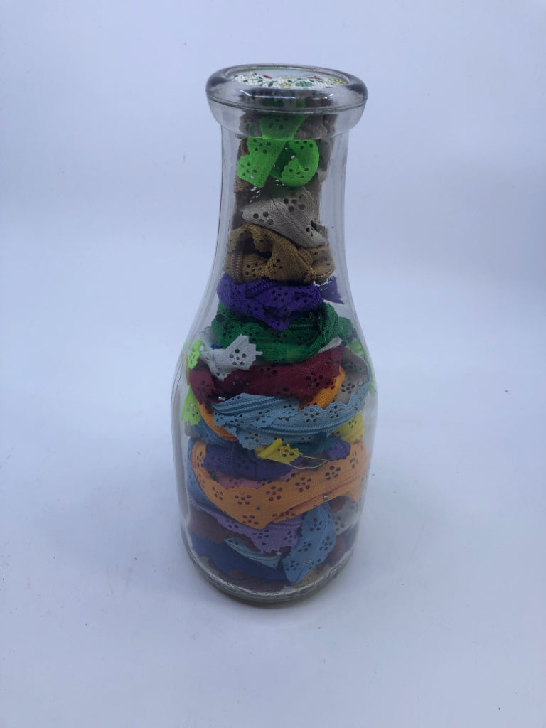 GLASS BOTTLE FILLED W/ZIPPER FABRIC DECOR.