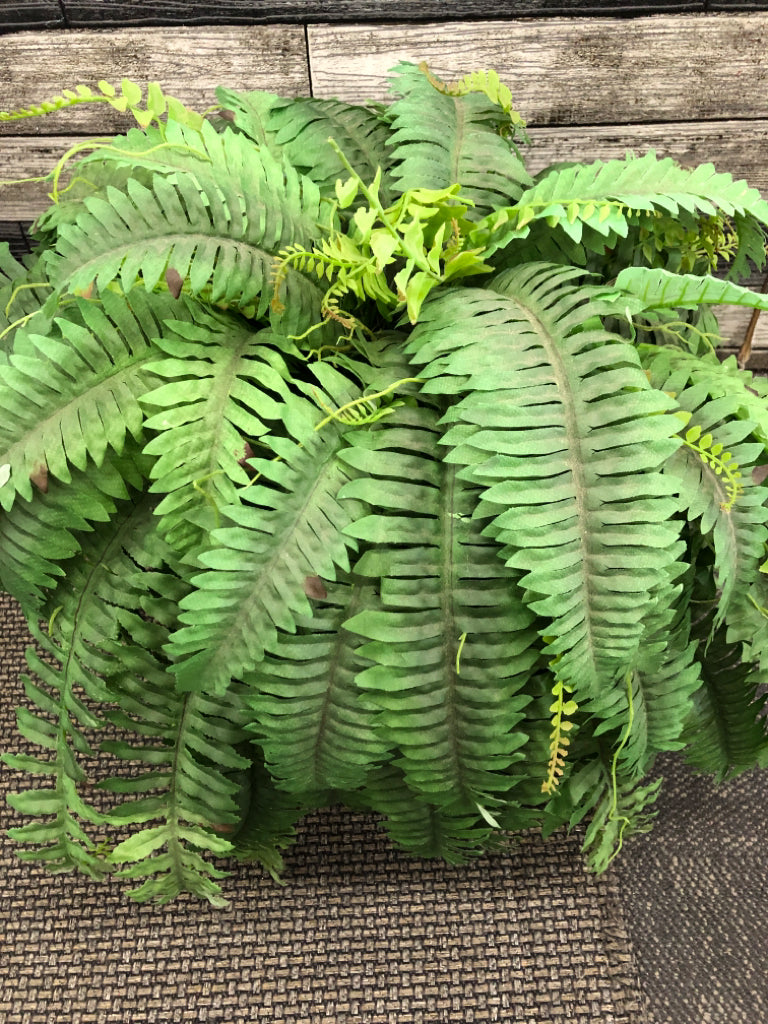 FAUX FERN IN BROWN CERAMIC PLANTER.