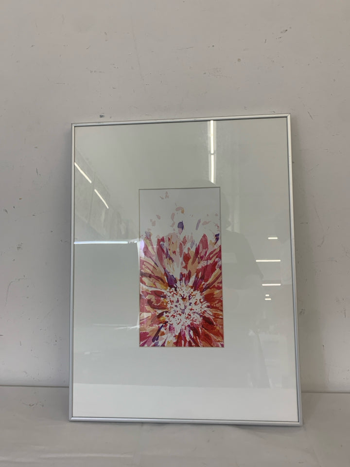 COLORED STARBURST IN WHITE FRAME SILVER TRIM WALL ART.