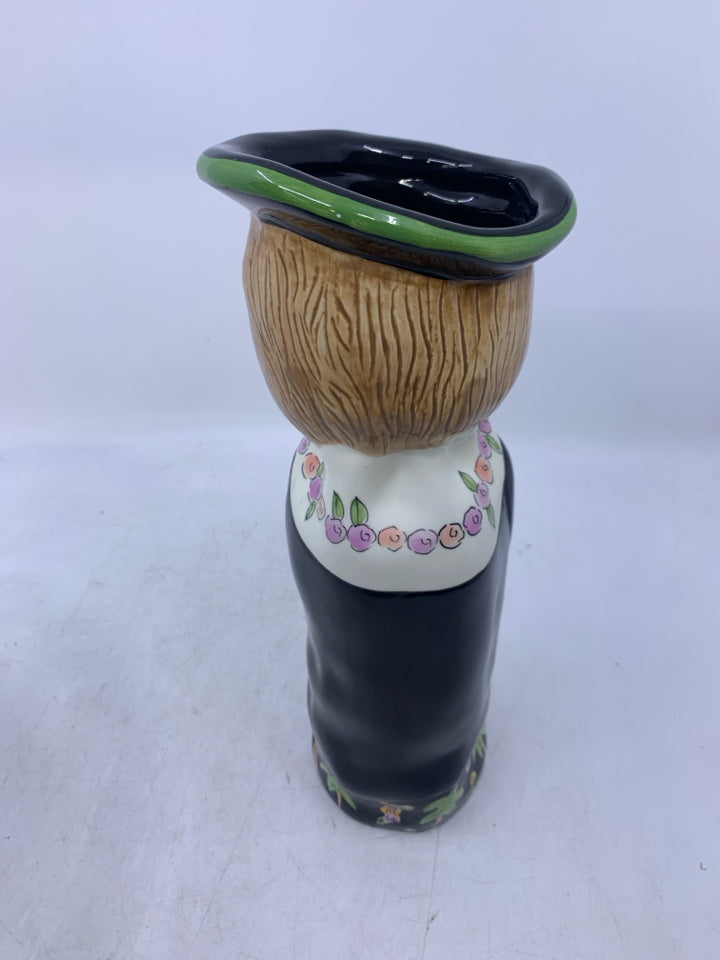 WOMAN SHAPED VASE W/ BLACK DRESS FLOWER NECKLACE.