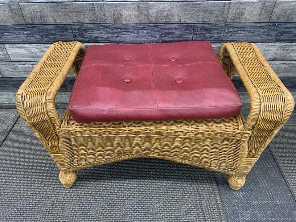 WICKER FOOT STOOL BENCH AND RED CUSHION.