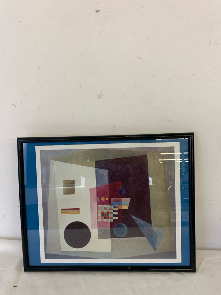 ABSTRACT WALL HANGING IN BLACK FRAME.