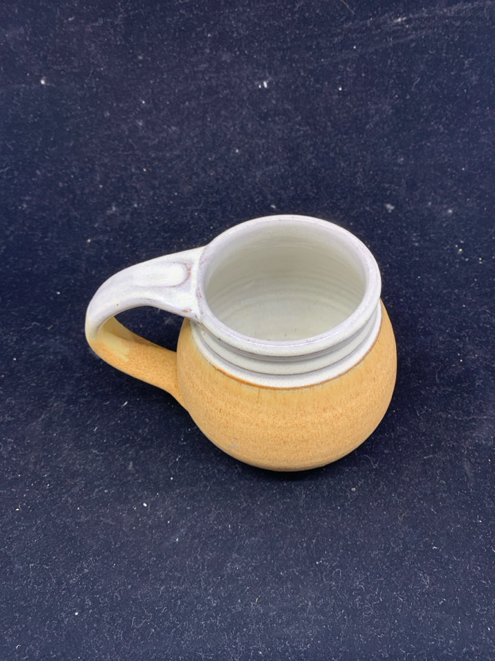 SMALL TAN POTTERY MUG.