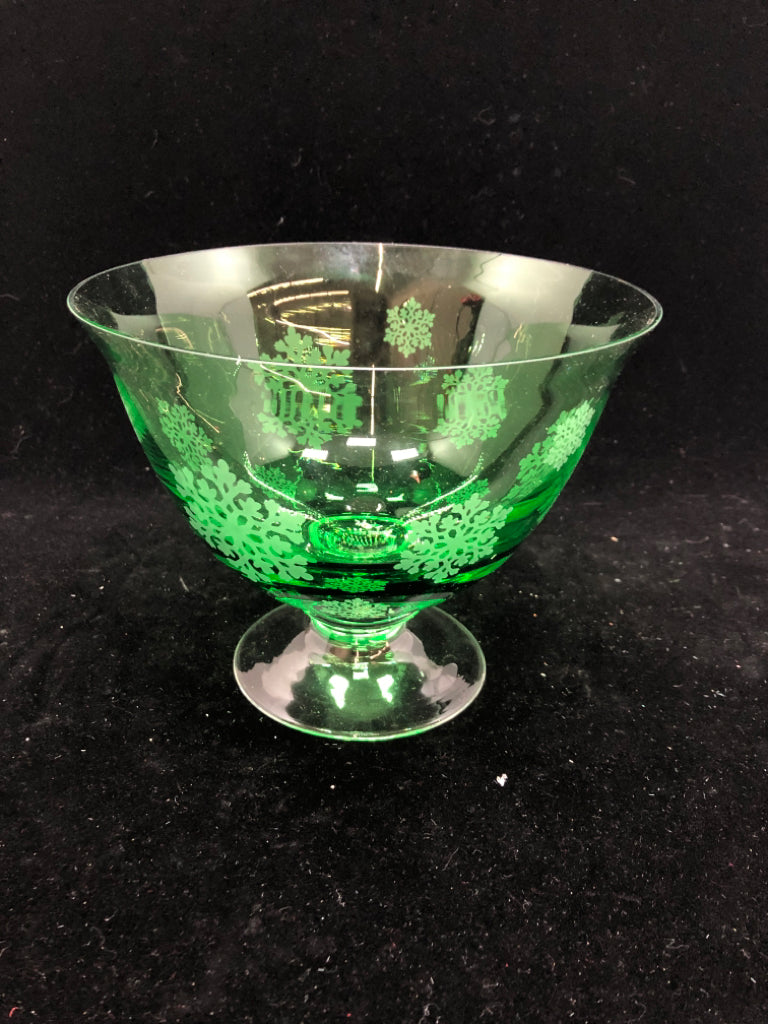 GREEN GLASS FOOTED BOWL W/EMBOSSED SNOWFLAKES.