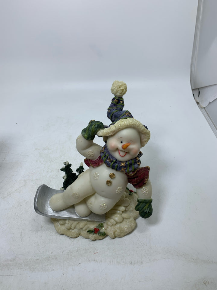 RESIN SNOWMAN ON SNOWBOARD.