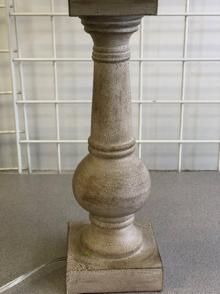 GRAY DISTRESSED LAMP WITH WHITE LAMP SHADE.