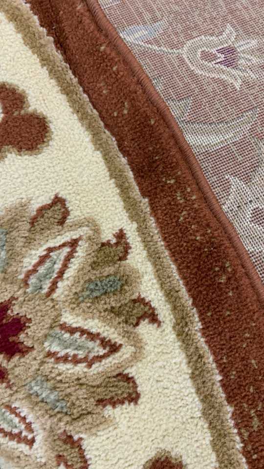 GOLDEN CIRCLE RUG W/LEAF DESIGNS.