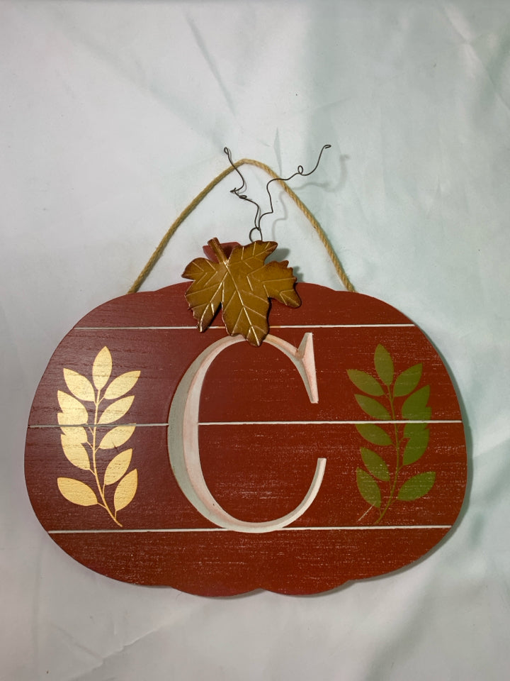 RED PUMPKIN SHAPED WALL ART W/ MONOGRAM C METAL LEAVES.