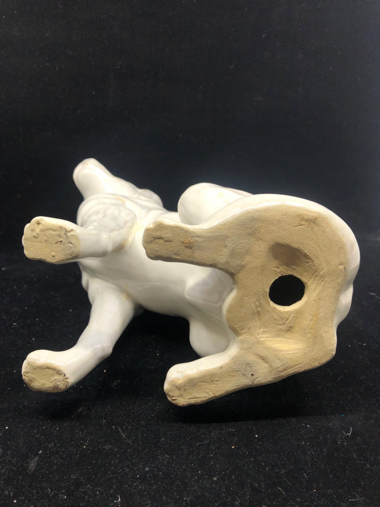 WHITE CERAMIC SITTING DOG.