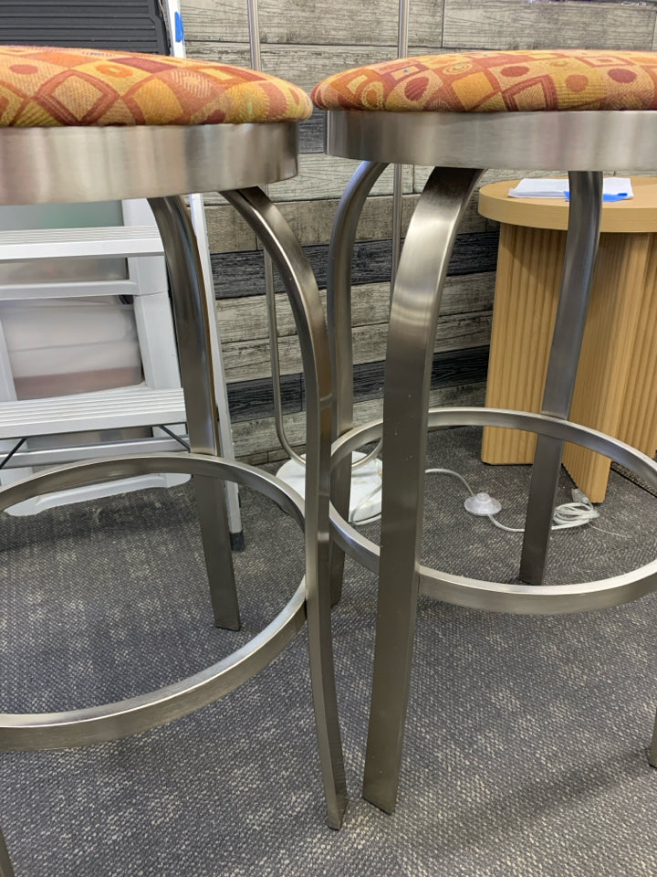 2 TALL SILVER LEG ORANGE CUSHION STOOLS.