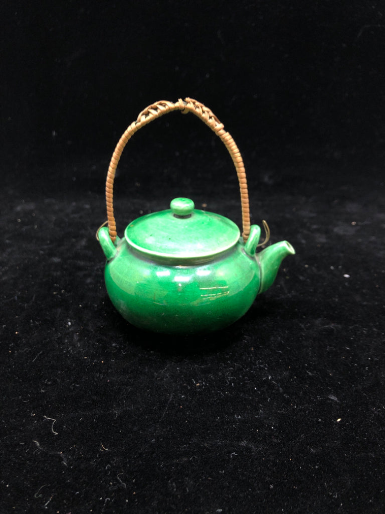 SMALL GREEN GLAZED TEA POT W/WICKER HANDLE.