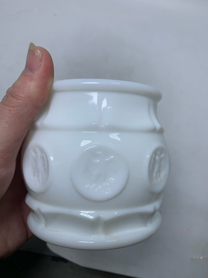 VTG SMALL MILK GLASS CANISTER W/ EAGLE COIN DETAILS.