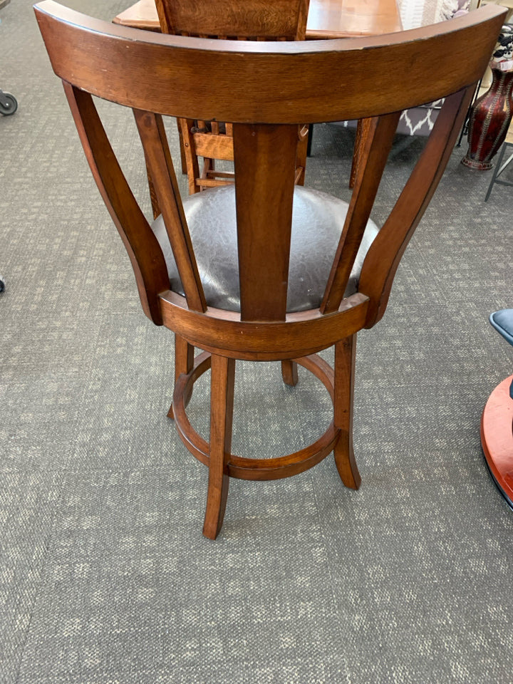DARK WOODEN BARSTOOL W/ FAUX LEATHER SEAT.