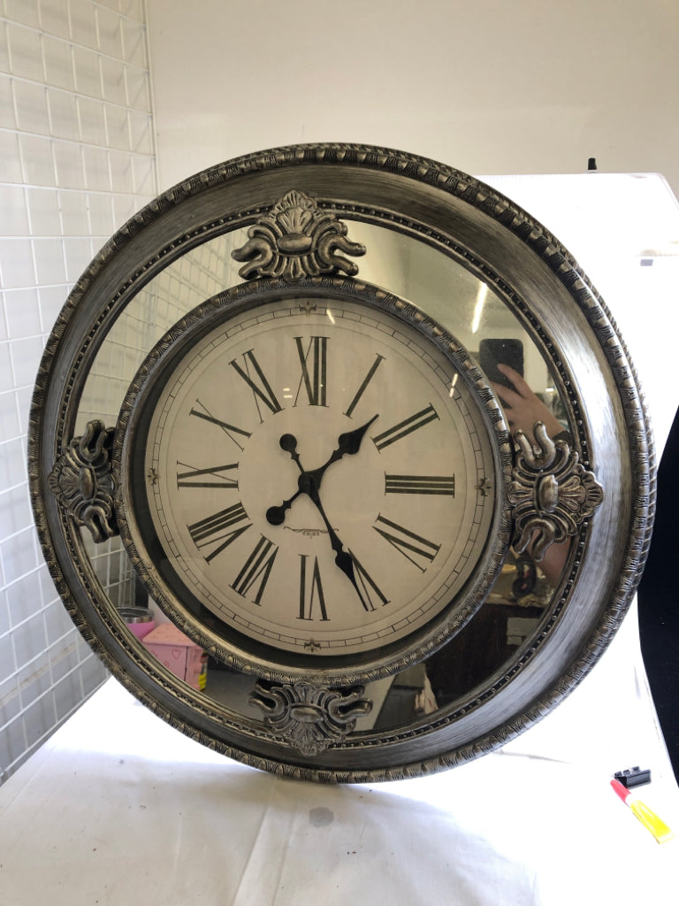 PLASTIC SILVER CLOCK W/ MIRRORS.