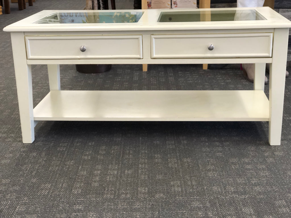 CREAM COFFEE TABLE W GLASS TOP AND 2 DRAWERS.