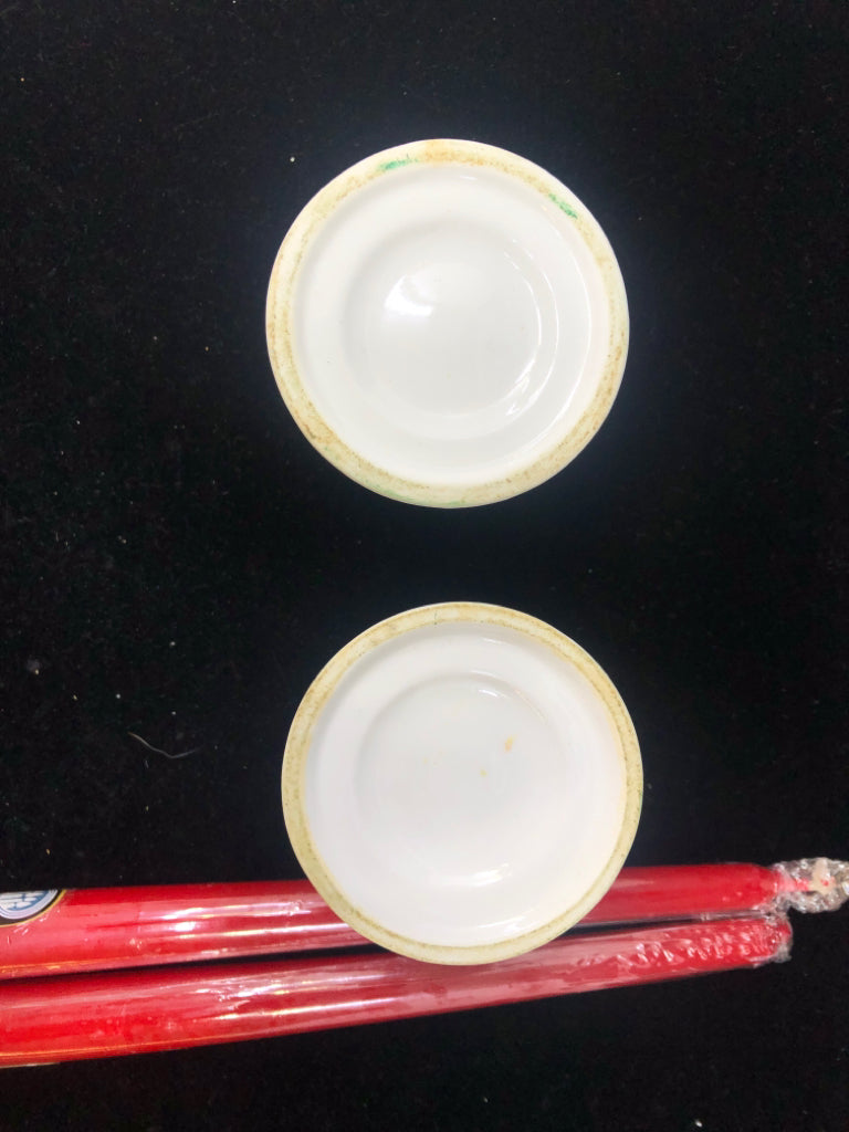 2 WHITE TAPER CANDLE HOLDERS-HOLLY & CANDY CANE WITH RED TAPER CANDLES.