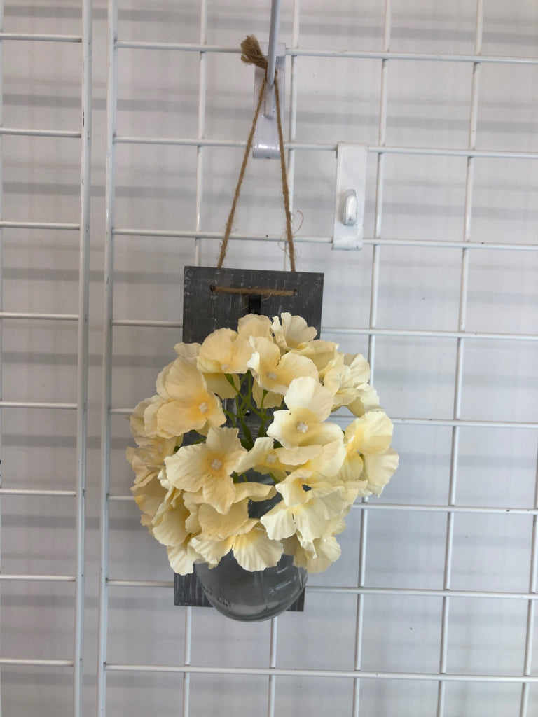 HANGING MASON JAR VASE W/FLORALS & GRAY WOOD BACK.
