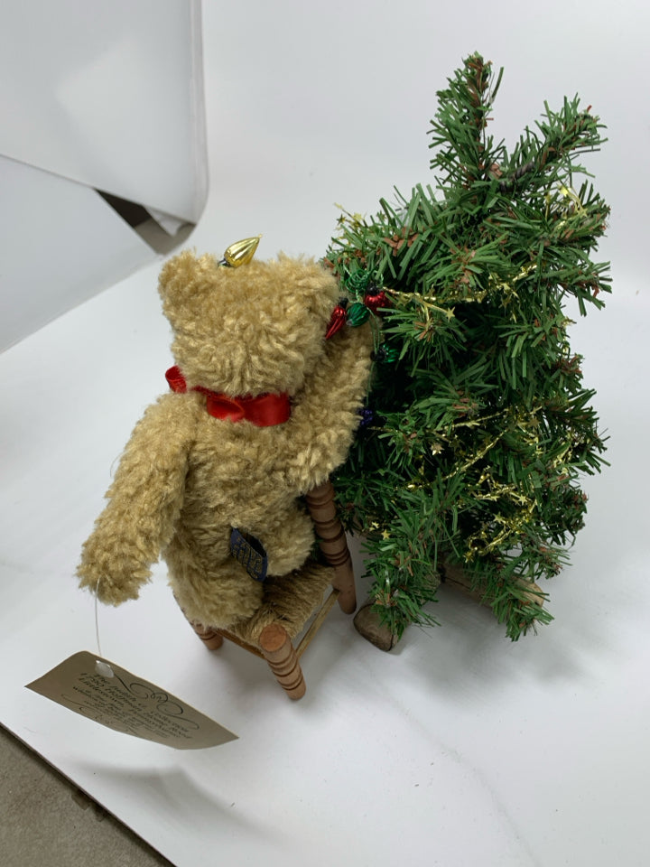 BOYDS BEAR SMALL BEAR PUTTING LIGHT ON TREE STANDING ON CHAIR.