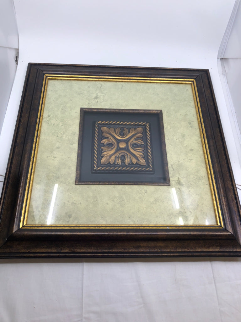 GOLD MEDALLION IN DARK BROWN FRAME.