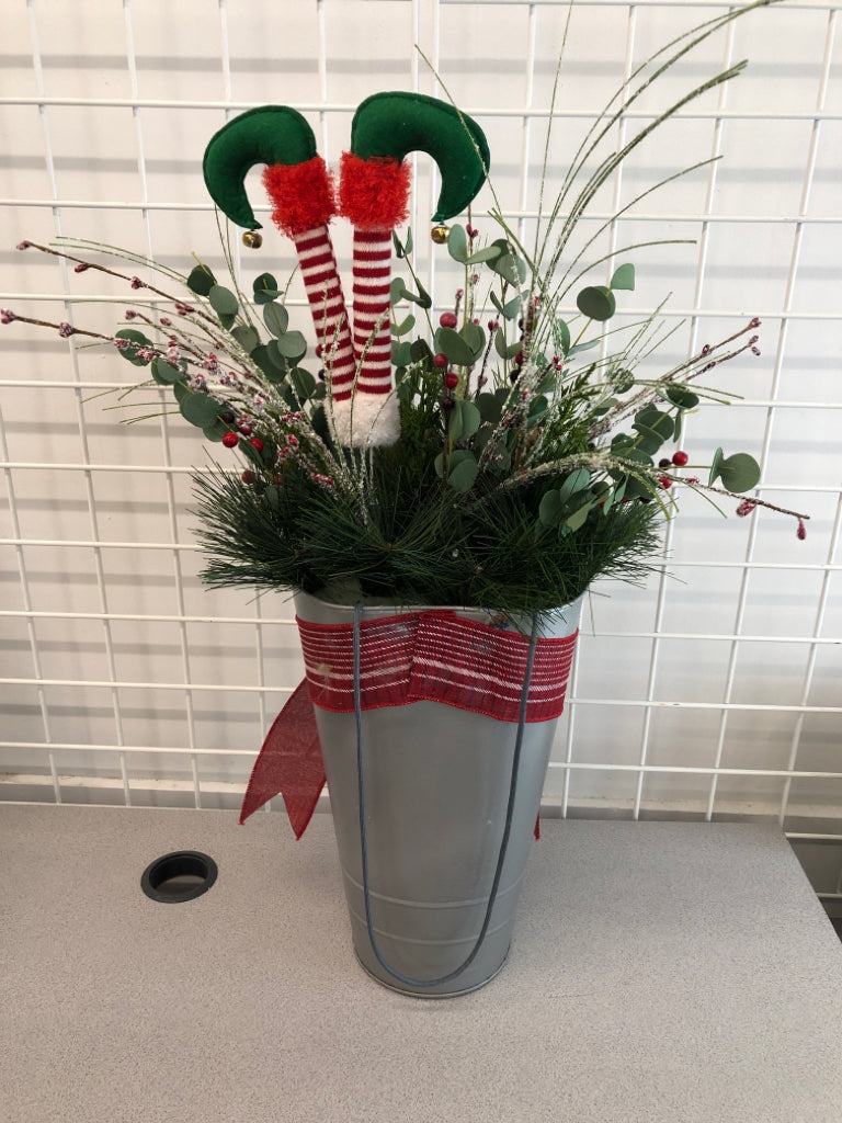 FAUX GREEN AND BERRIES ELF LEGS IN TIN W/RED RIBBON.
