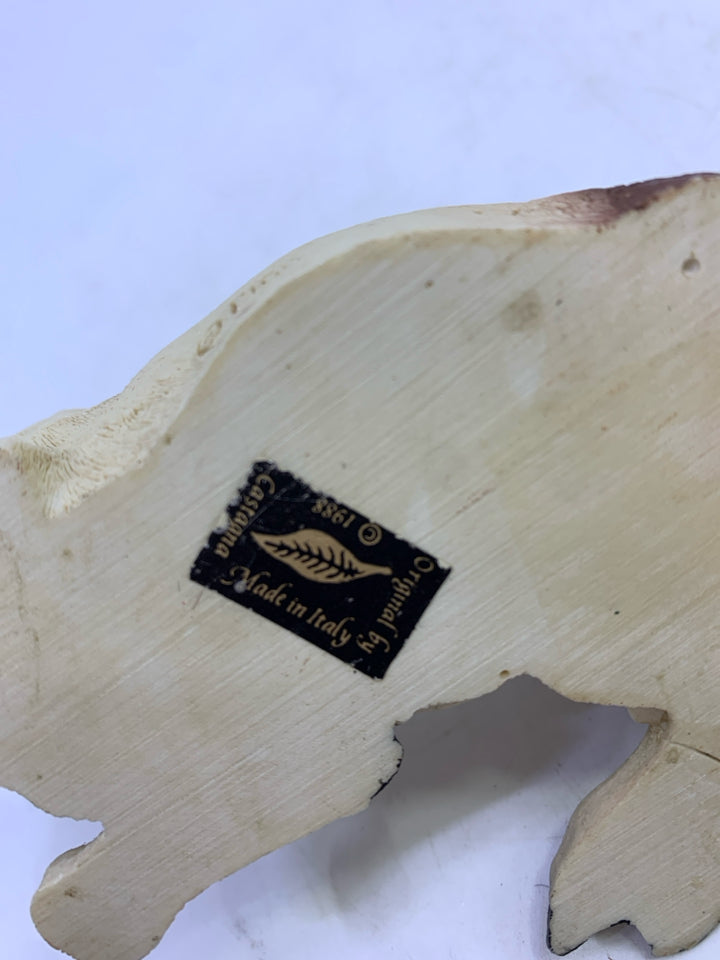 BROWN/WHITE COW LAYING.