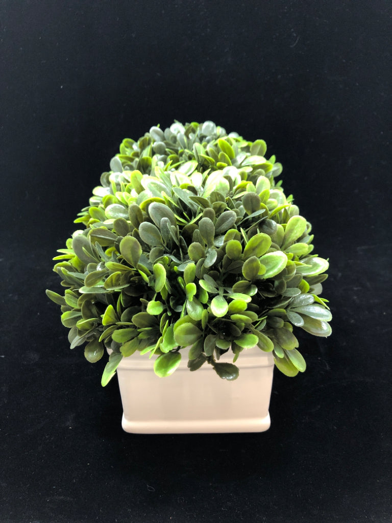 FAUX GREENS IN WHITE CERAMIC PLANTER.