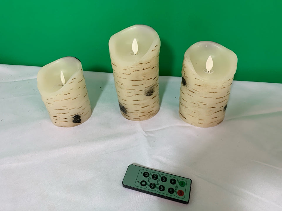 3 WHITE BIRCH WOOD BATTERY OPERATED CANDLES WITH REMOTE.