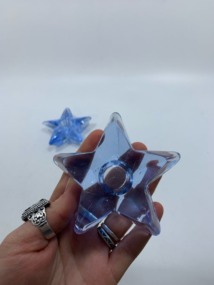 2 LIGHT BLUE STAR SHAPED GLASS TAPERED CANDLE HOLDERS.