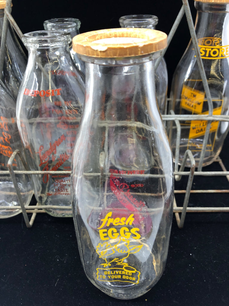 METAL CRATE + 8 DECORATIVE VTG MILK BOTTLES.