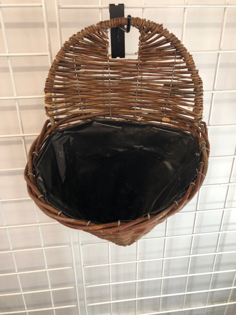BROWN WICKER WALL PLANT HOLDER.
