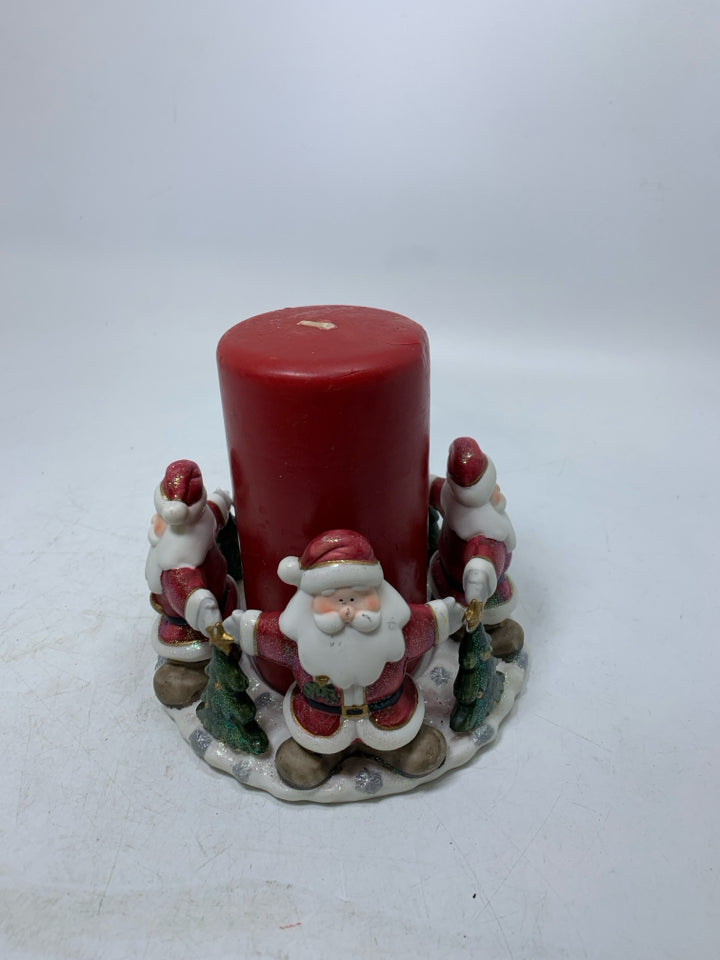 CERAMIC SANTA TOUCHING HANDS BASE W/ RED PILLAR CANDLE.