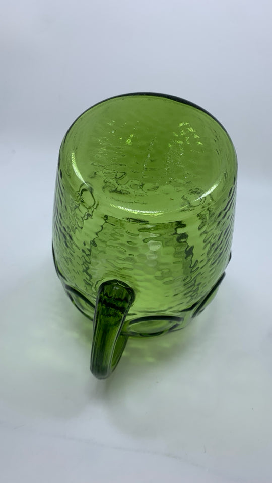 VTG GREEN GLASS PITCHER W/TEXTURED BULLSEYE PATTERN.